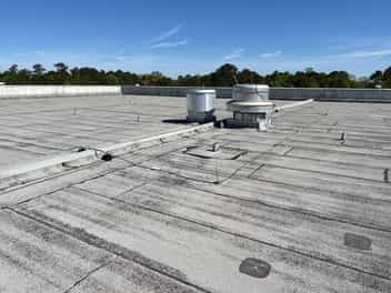 Picture of a gray colored modified bitumen flat roofing material on an office building